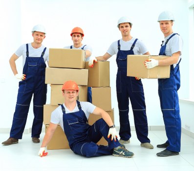 Removal team handling furniture and boxes for a home or office move in Twickenham