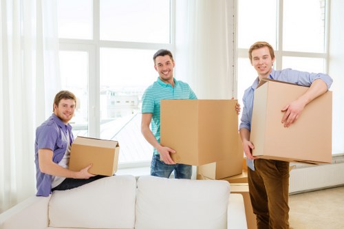 Boxes and furniture being loaded into a local removal van