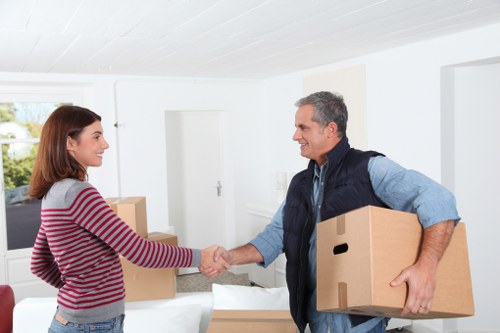 Professional packers preparing fragile household items for transport