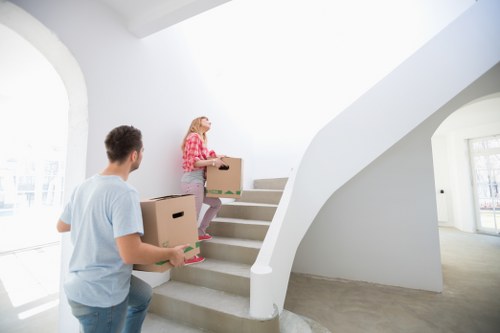 Packed moving boxes and protected furniture ready for removal in Twickenham