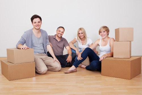 Local moving team handling boxes in a Twickenham residential area